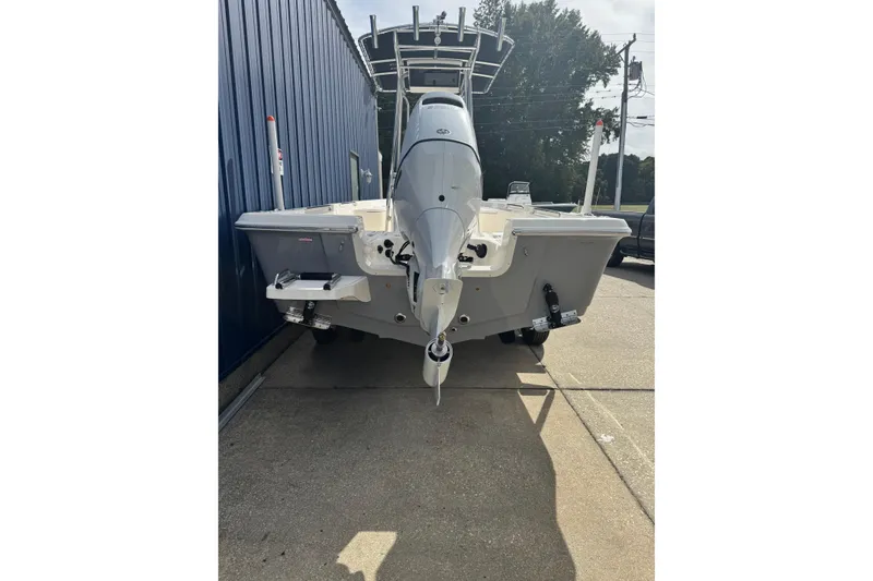 Slide: The Image of 2026 Bulls Bay 2200 boat with Suzuki outboard motor, white deck, and storage compartments. - 2