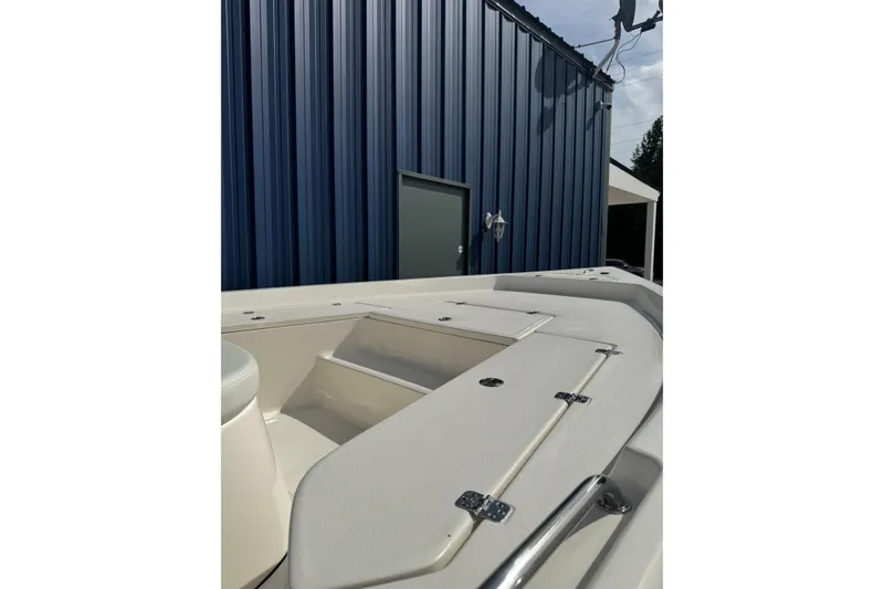 Slide: The Image of 2026 Bulls Bay 2200 boat with T-top and rod holders, parked outdoors. - 8