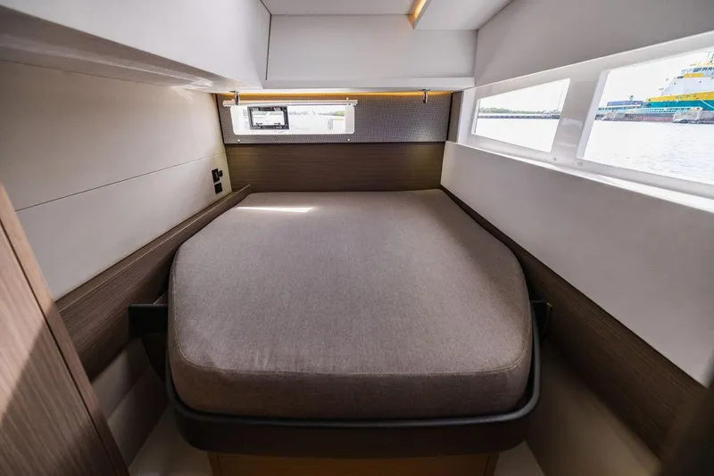 Slide: The Image of 2024 Leopard 45 yacht interior cabin with bed and windows. - 23
