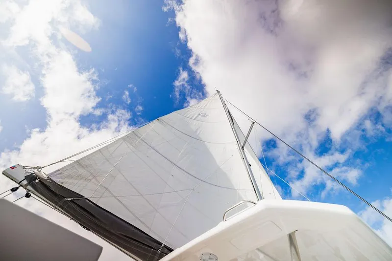 Slide: The Image of Sailing yacht Leopard 45, 2024 model, against a bright blue sky with clouds. - 46