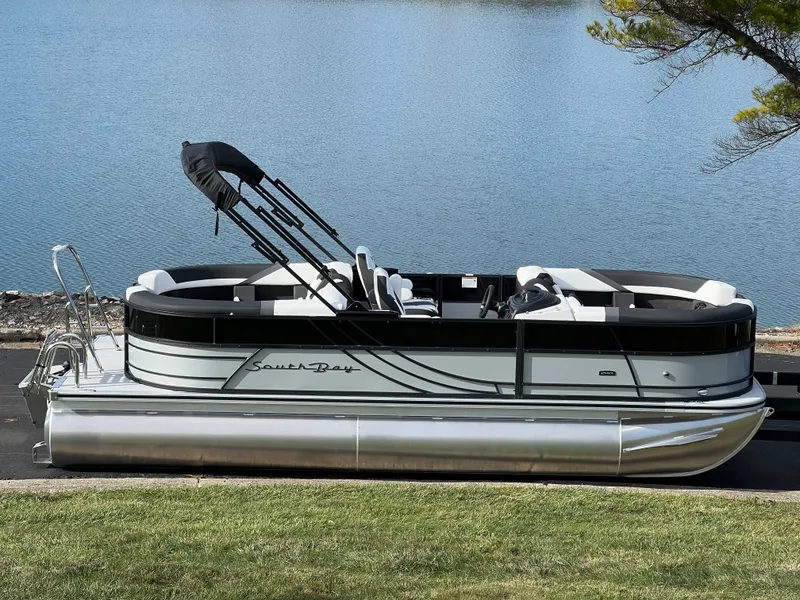 Slide: The Image of 2025 South Bay 222RS pontoon boat by a serene lake. - 1