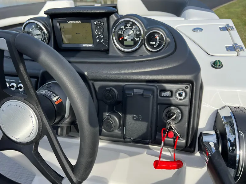 Slide: The Image of 2025 South Bay 222RS boat dashboard with steering wheel and control panel. - 24