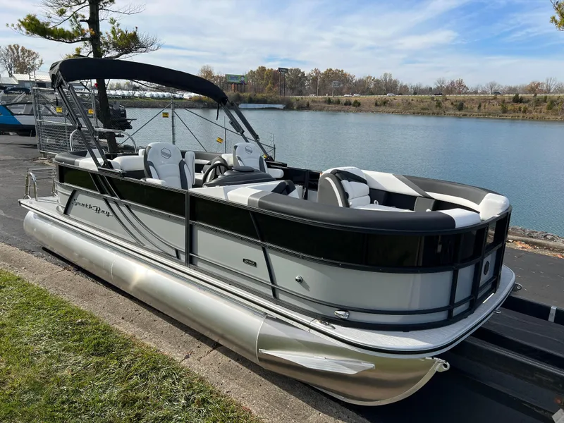 Slide: The Image of 2025 South Bay 222RS pontoon boat docked by a serene lake. - 3