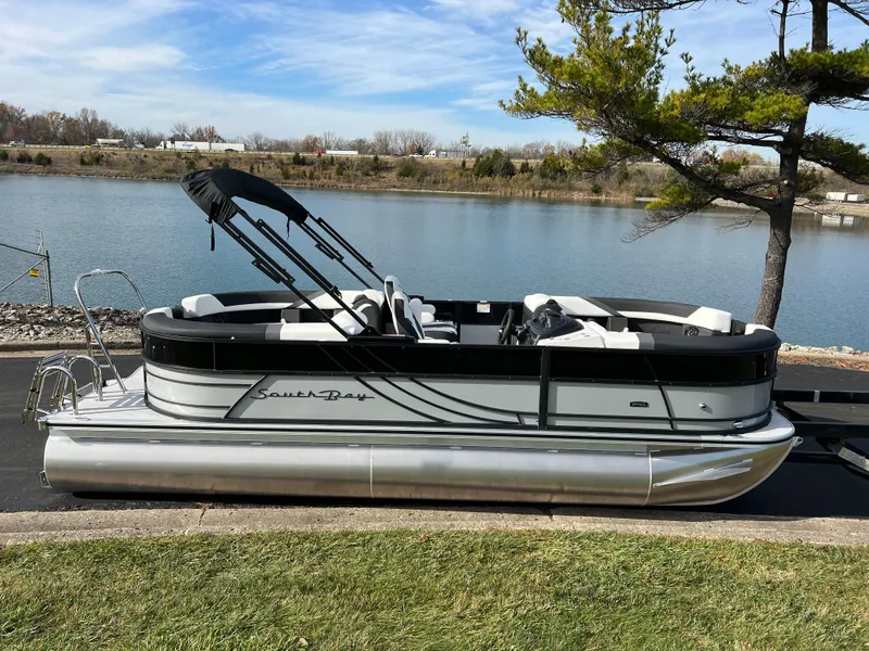Slide: The Image of 2025 South Bay 222RS pontoon boat by a serene lake. - 4