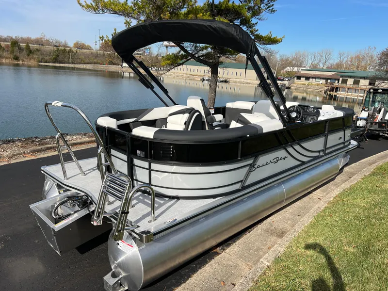 Slide: The Image of 2025 South Bay 222RS pontoon boat docked by a serene lake. - 5