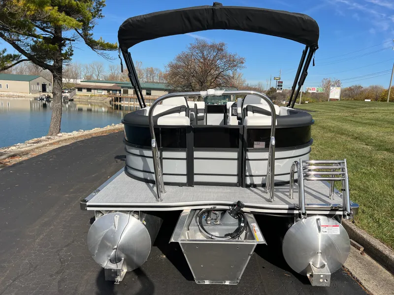 Slide: The Image of 2025 South Bay 222RS pontoon boat docked by a serene lakeside. - 6