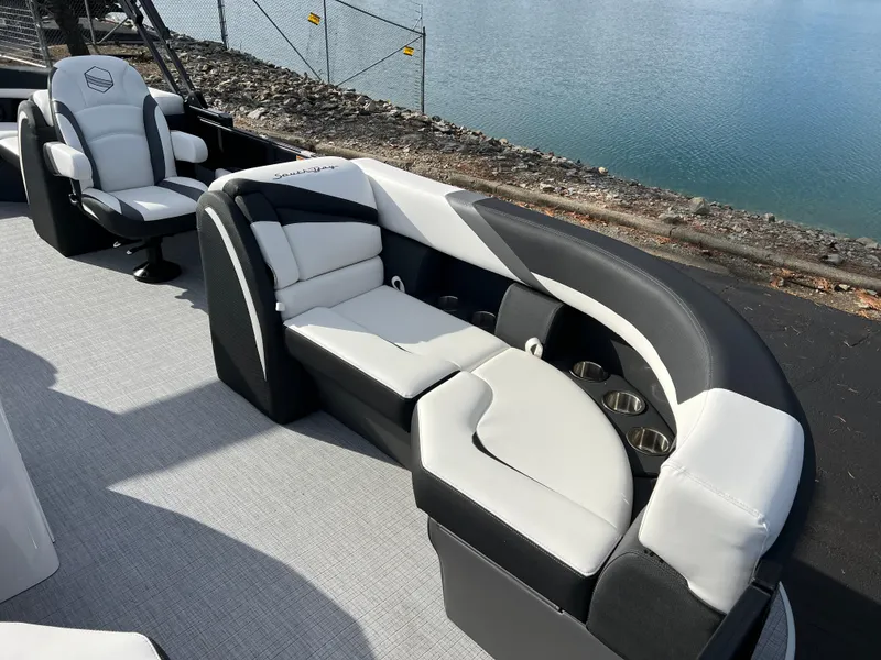 Slide: The Image of 2025 South Bay 222RS boat with luxurious seating by the water. - 9
