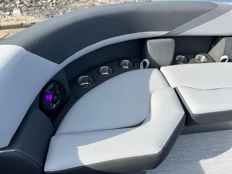 Slide: The Image of Luxurious seating on 2025 South Bay 220RS boat with cup holders and speaker. - 14