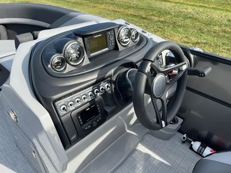 Slide: The Image of 2025 South Bay 220RS boat dashboard with modern controls and steering wheel. - 18