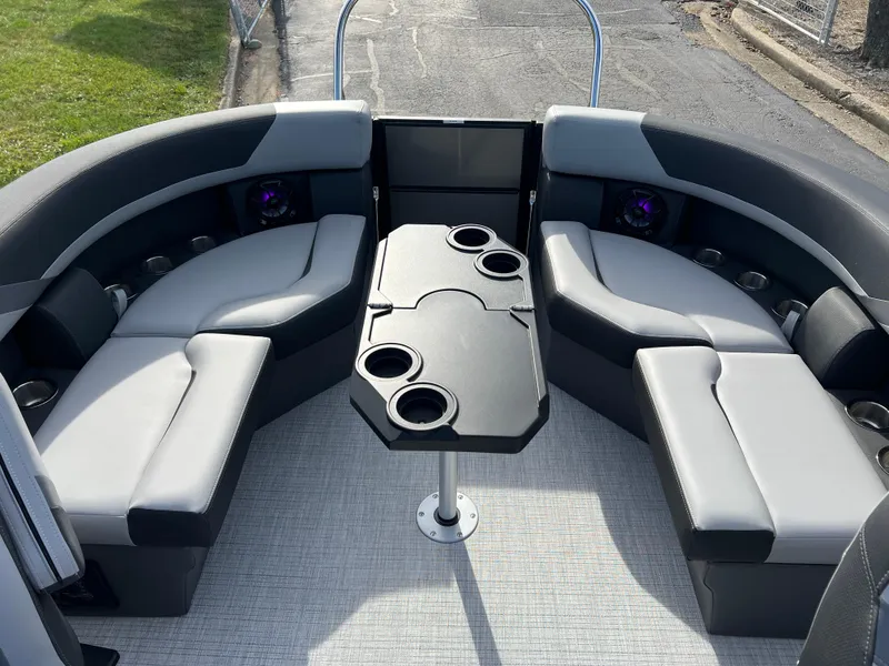 Slide: The Image of 2025 South Bay 220RS boat interior with gray seating and central table. - 23