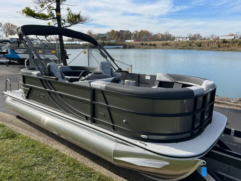 Slide: The Image of 2025 South Bay 220RS pontoon boat docked by a serene lake. - 3