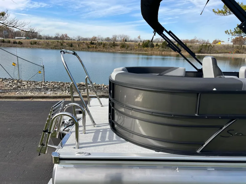Slide: The Image of 2025 South Bay 220RS pontoon boat by a serene lake. - 5