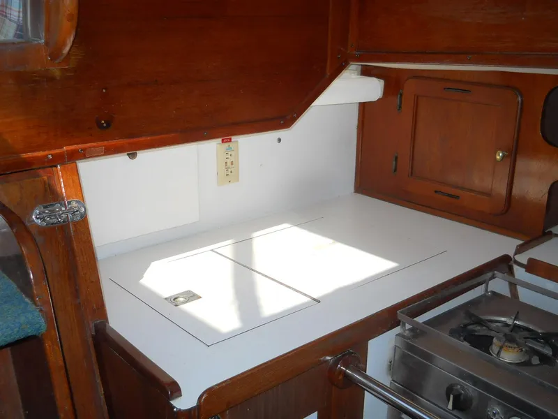 Slide: The Image of 1979 Morgan 382 yacht interior kitchen with wooden cabinetry and stove. - 12