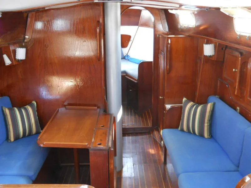 Slide: The Image of 1979 Morgan 382 yacht interior with wooden finish and blue seating. - 15