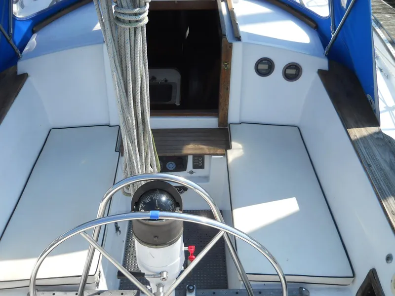 Slide: The Image of Cockpit of a 1979 Morgan 382 sailboat with steering wheel and seating. - 16