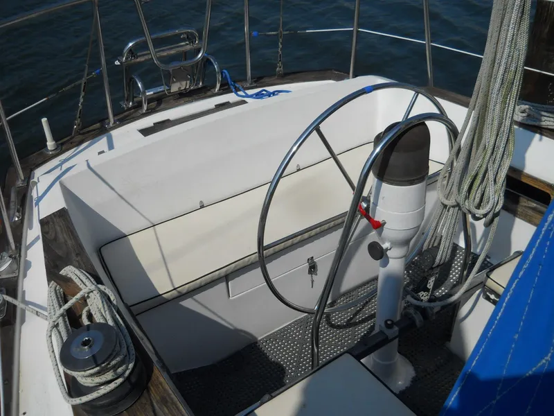 Slide: The Image of 1979 Morgan 382 sailboat cockpit with steering wheel and ropes, showcasing nautical design. - 20