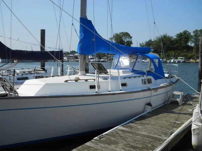 Slide: The Image of 1979 Morgan 382 sailboat docked at marina with blue sail cover. - 23
