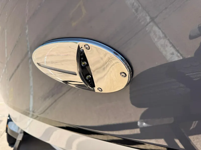 Slide: The Image of 2025 Regal LS2 Surf boat detail, featuring a sleek chrome fixture on the hull. - 14
