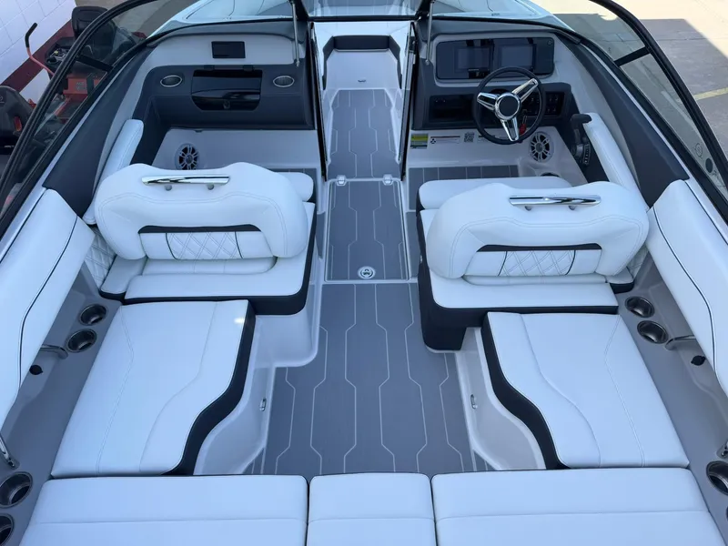 Slide: The Image of 2025 Regal LS2 Surf boat interior with luxurious white seating and modern dashboard design. - 19