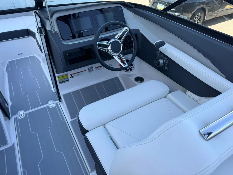 Slide: The Image of 2025 Regal LS2 Surf boat interior with sleek steering and modern dashboard design. - 20