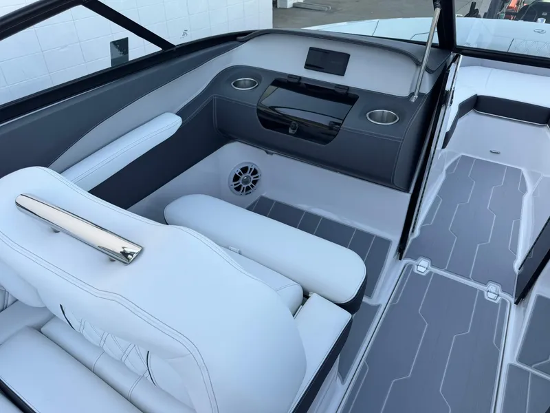 Slide: The Image of 2025 Regal LS2 Surf boat interior with white seating and modern dashboard design. - 21