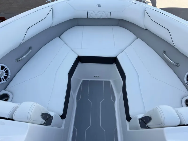 Slide: The Image of 2025 Regal LS2 Surf boat interior with white cushioned seating and sleek design. - 22