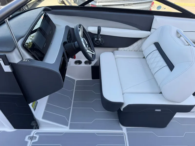 Slide: The Image of 2025 Regal LS2 Surf boat interior with modern dashboard and white seating. - 23