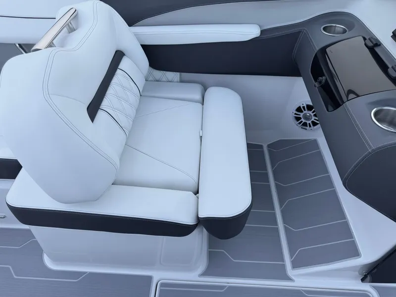 Slide: The Image of 2025 Regal LS2 Surf boat interior with white seating and cup holders. - 24