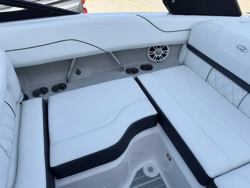 Slide: The Image of 2025 Regal LS2 Surf boat interior with white seating and cup holders. - 27