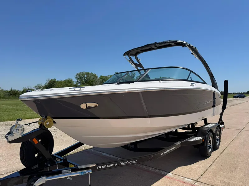 Slide: The Image of 2025 Regal LS2 Surf boat on trailer, sleek design, sunny day. - 4