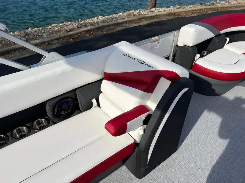 Slide: The Image of Luxurious seating on 2025 South Bay S 220 CR2 pontoon boat by the water. - 18