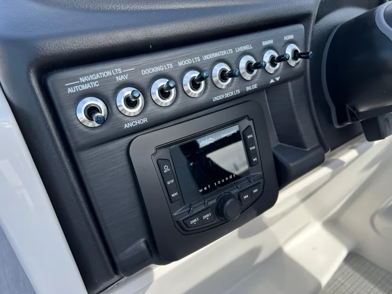 Slide: The Image of Control panel of 2025 South Bay S 220 CR2 boat with switches and display. - 20