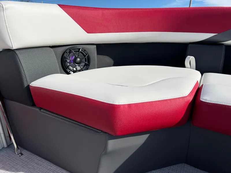 Slide: The Image of 2025 South Bay S 220 CR2 boat interior with red and white seating and speaker. - 25