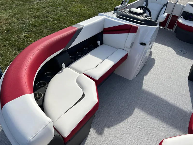 Slide: The Image of 2025 South Bay S 220 CR2 pontoon boat with red and white seating. - 9