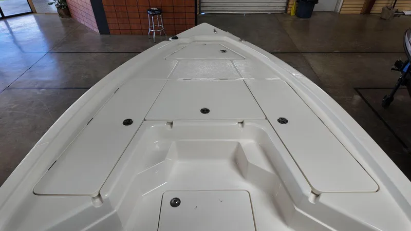 Slide: The Image of 2025 Skeeter SX 221 boat deck in showroom, featuring storage compartments. - 10