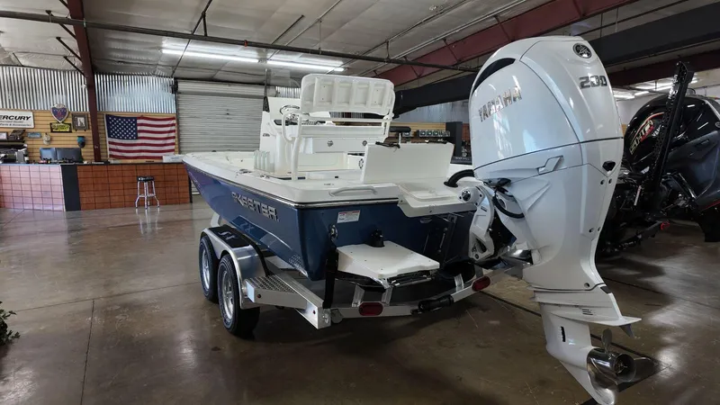 Slide: The Image of 2025 Skeeter SX 221 boat with powerful outboard motor in showroom. - 3