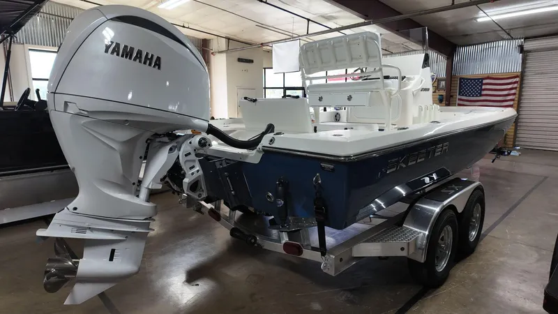 Slide: The Image of 2025 Skeeter SX 221 boat with Yamaha engine on trailer in garage. - 4