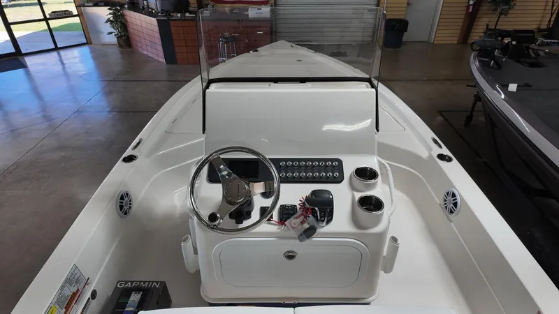Slide: The Image of 2025 Skeeter SX 221 boat interior with steering console and controls in showroom. - 5