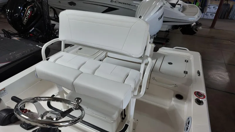 Slide: The Image of 2025 Skeeter SX 221 boat interior with white seating and steering wheel. - 9