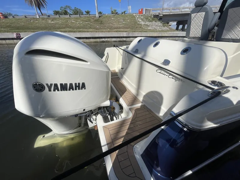 Slide: The Image of 2021 Chris-Craft Catalina 30 with Yamaha outboard engine, docked in a sunny marina. - 3