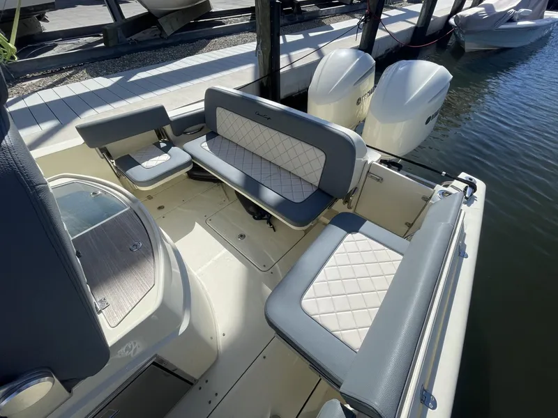 Slide: The Image of 2021 Chris-Craft Catalina 30 boat interior with cushioned seating and dual outboard engines. - 5