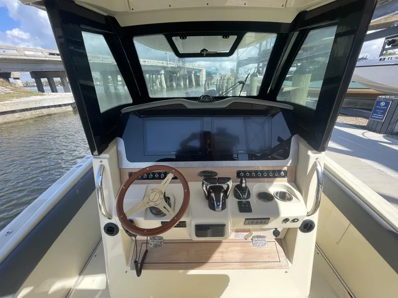 Slide: The Image of 2021 Chris-Craft Catalina 30 helm with modern controls and wooden steering wheel. - 7