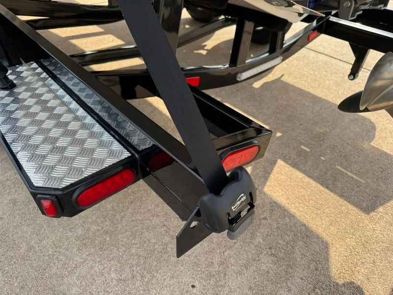 Slide: The Image of 2025 Regal LS4 Surf trailer with safety strap and reflective lights. - 18