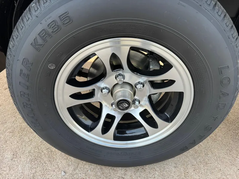 Slide: The Image of 2025 Regal LS4 Surf wheel with Load Star KR35 tire on concrete surface. - 19