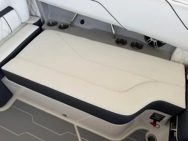 Slide: The Image of 2025 Regal LS4 Surf boat interior with cushioned seating and cup holders. - 23