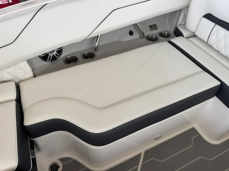 Slide: The Image of 2025 Regal LS4 Surf boat interior with cushioned seating and cup holders. - 24