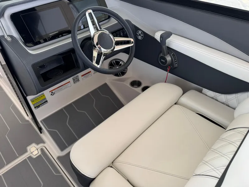 Slide: The Image of 2025 Regal LS4 Surf boat interior with modern steering and control panel. - 26