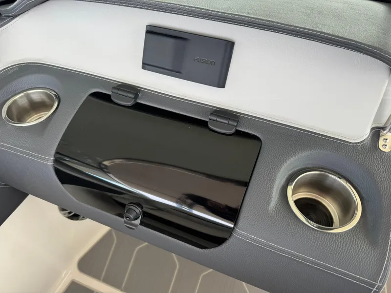 Slide: The Image of 2025 Regal LS4 Surf dashboard with cup holders and sleek black panel. - 27