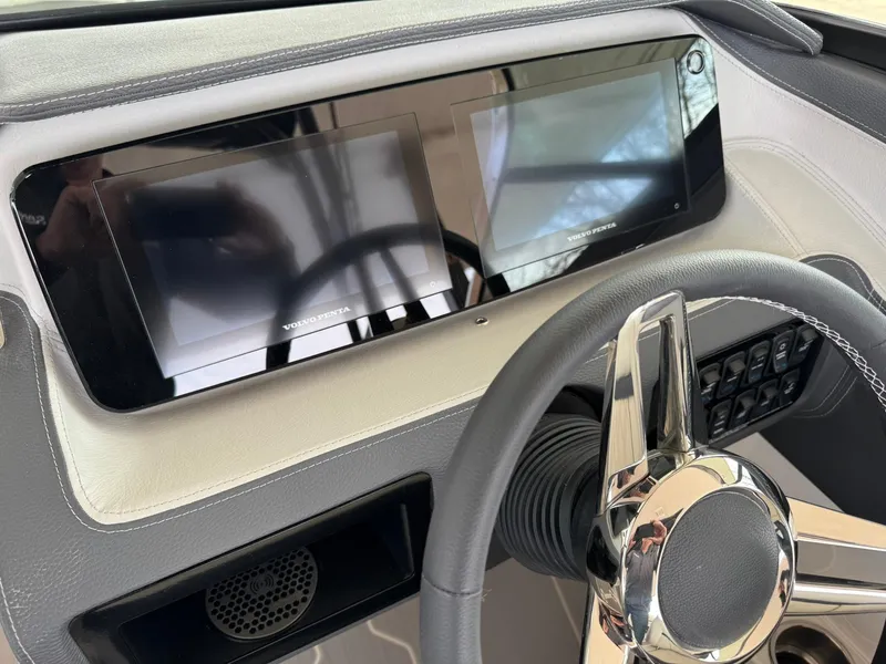 Slide: The Image of 2025 Regal LS4 Surf dashboard with dual screens and sleek steering wheel. - 28