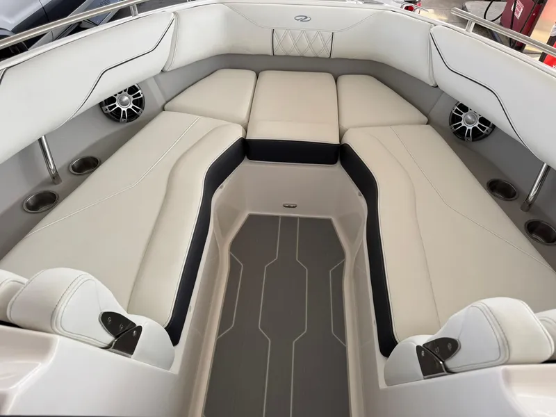 Slide: The Image of 2025 Regal LS4 Surf boat interior with white cushioned seating and built-in speakers. - 29